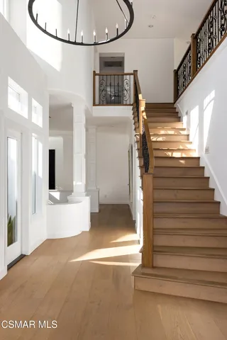 a view of an empty room with a fireplace and a large window