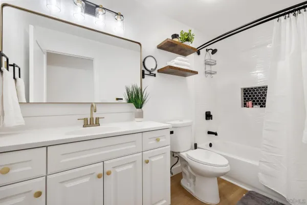 a view of bathroom with a sink mirror and toilet