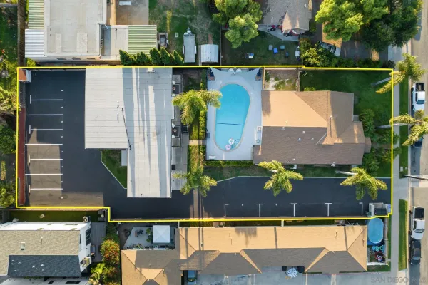 an aerial view of houses with a swimming pool