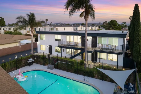 a view of a balcony with swimming pool and furniture