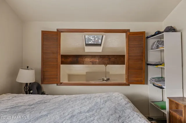 a bedroom with a bed and a window