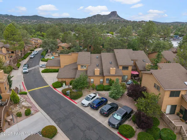 an aerial view of a house with swimming pool and mountains