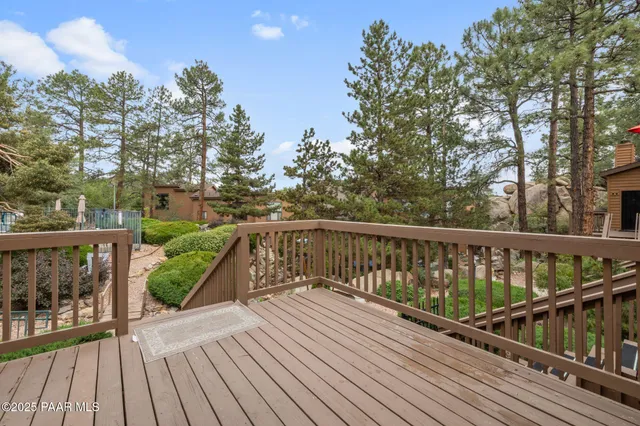 a view of balcony with wooden floor and fence