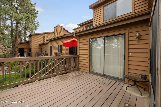a view of a wooden balcony with furniture