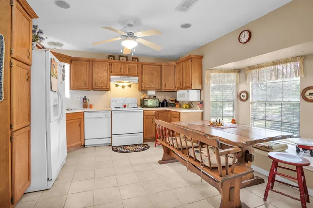a kitchen with stainless steel appliances kitchen island granite countertop a sink and cabinets