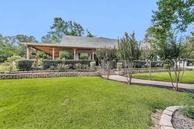 a view of a house with a yard patio and swimming pool
