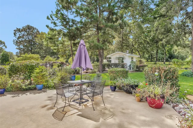 a view of a chair and table in backyard