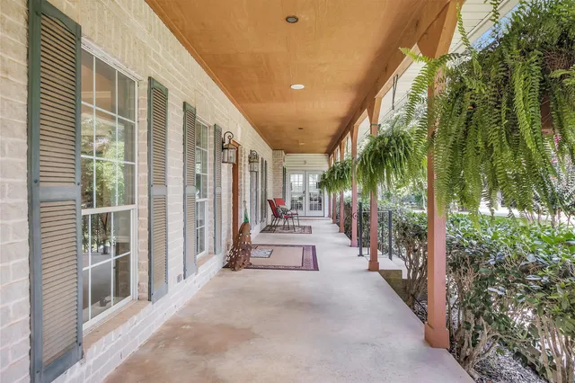 a view of a patio with couches and potted plants