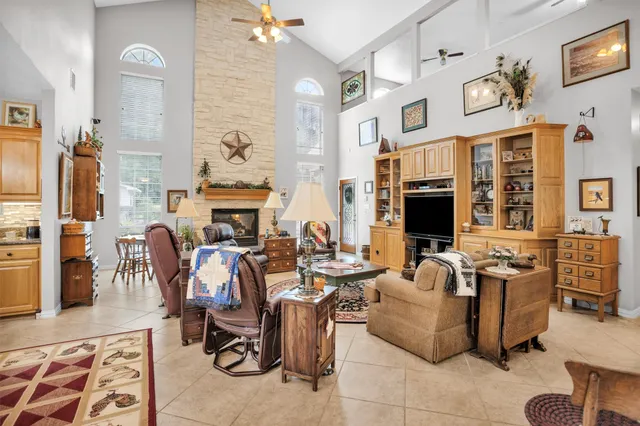a living room with fireplace furniture and a flat screen tv