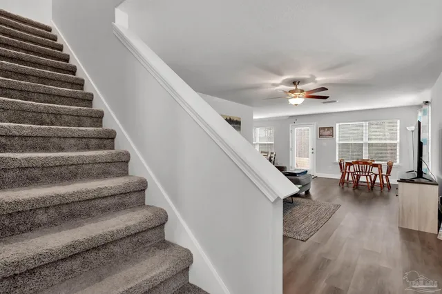 a view of entryway and hall with wooden floor