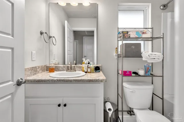 a bathroom with a sink toilet vanity and tub