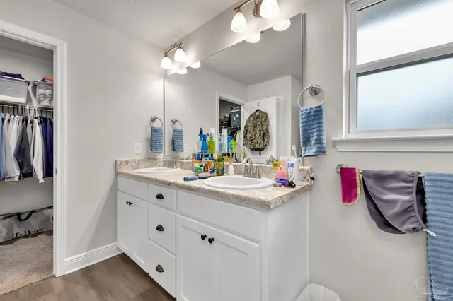 a bathroom with a sink vanity and a mirror