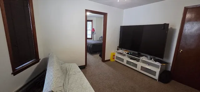 a bedroom with bed and window