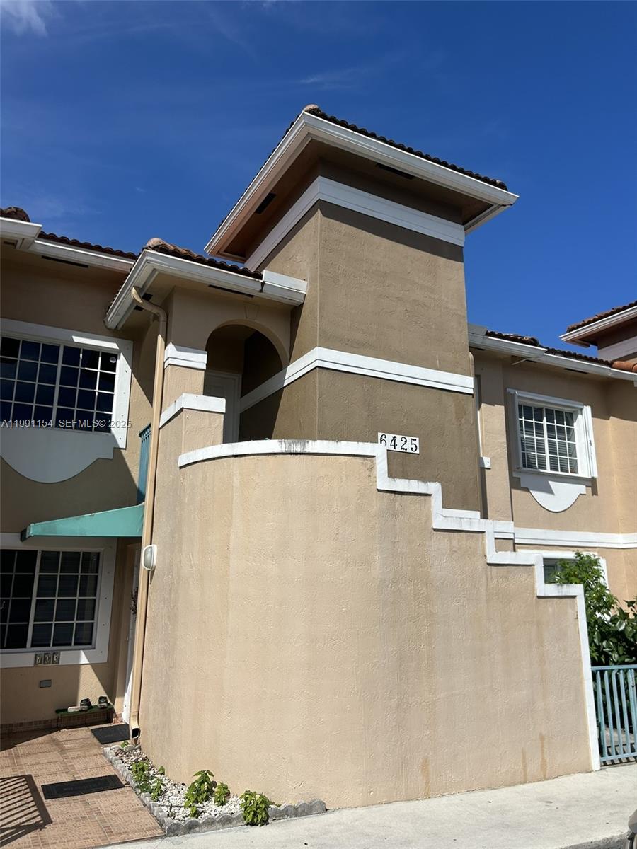 6425 Southwest 130th Place, Unit 704 Miami, FL 33183 - Photo 1 of 6 a front view of a house with garage