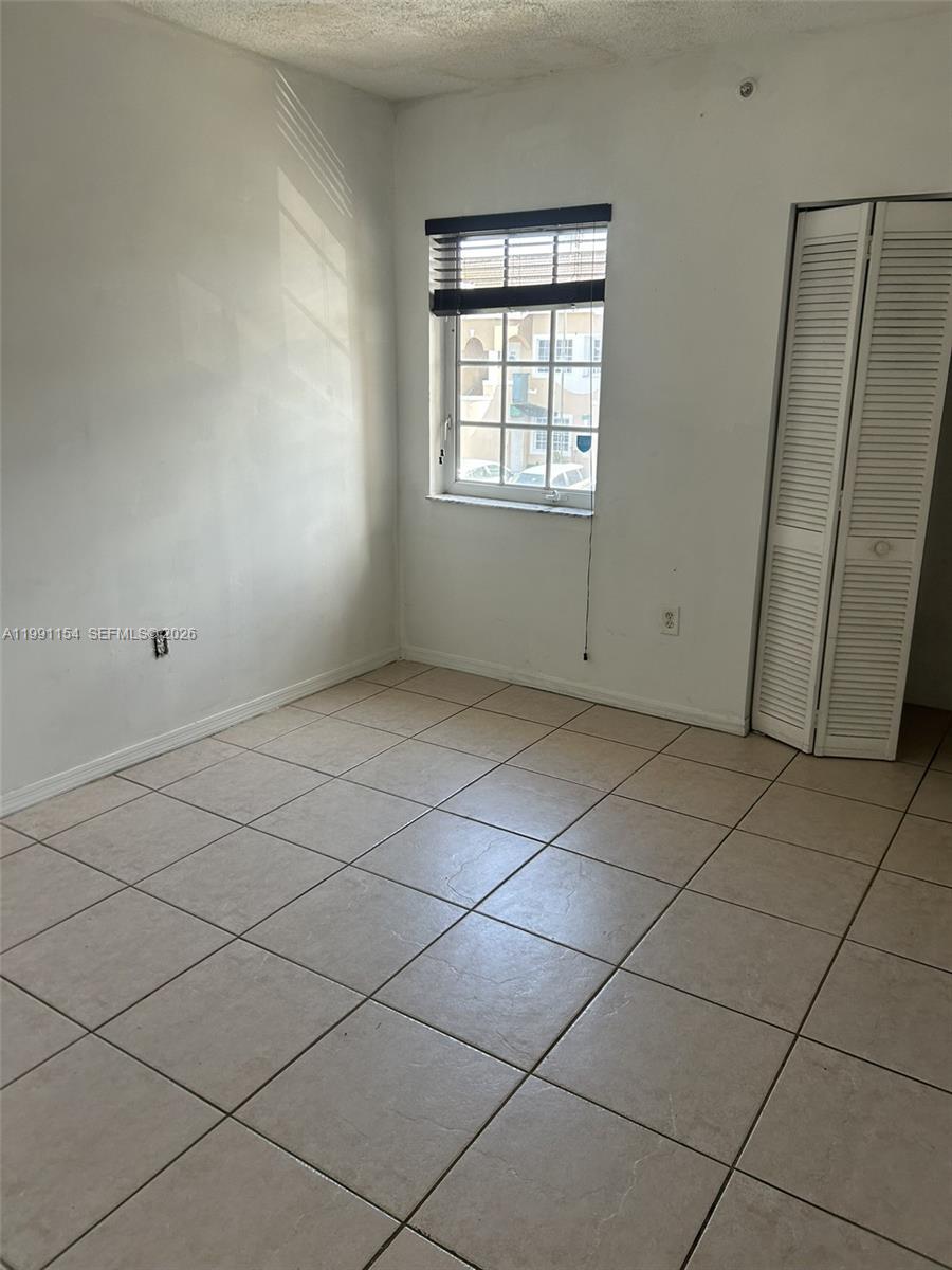 6425 Southwest 130th Place, Unit 704 Miami, FL 33183 - Photo 3 of 6 an empty room with windows