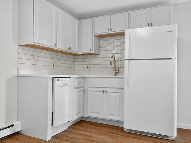 a white refrigerator freezer sitting inside of a kitchen