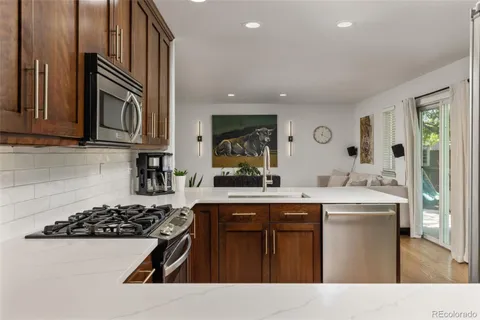a kitchen with stainless steel appliances a sink stove and cabinets