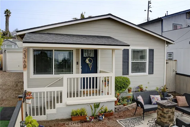 a view of a house with a bench in patio