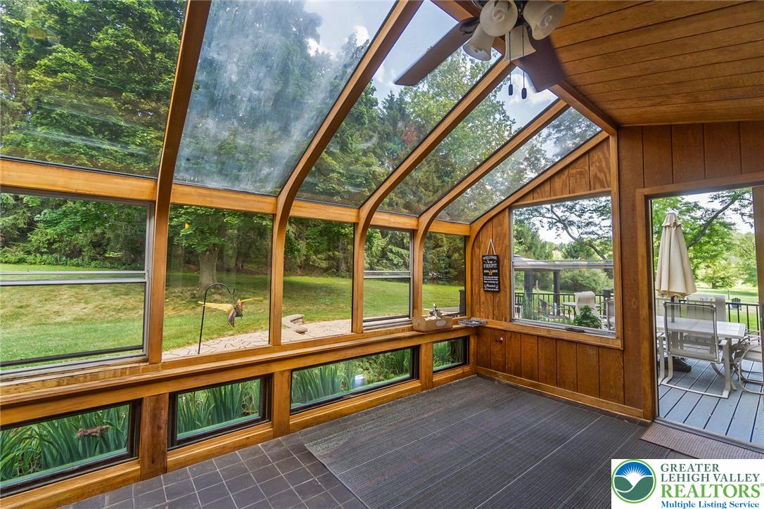 1553 Surrey Road Bethlehem, PA 18015 - Photo 30 of 92 A glass-enclosed sunroom offers abundant natural light and seamless views of the surrounding natural landscape.