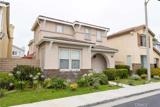 a front view of a house with garden