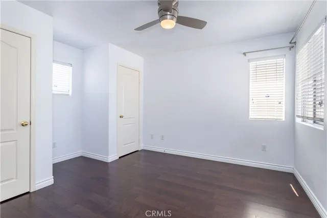 an empty room with wooden floor and closet