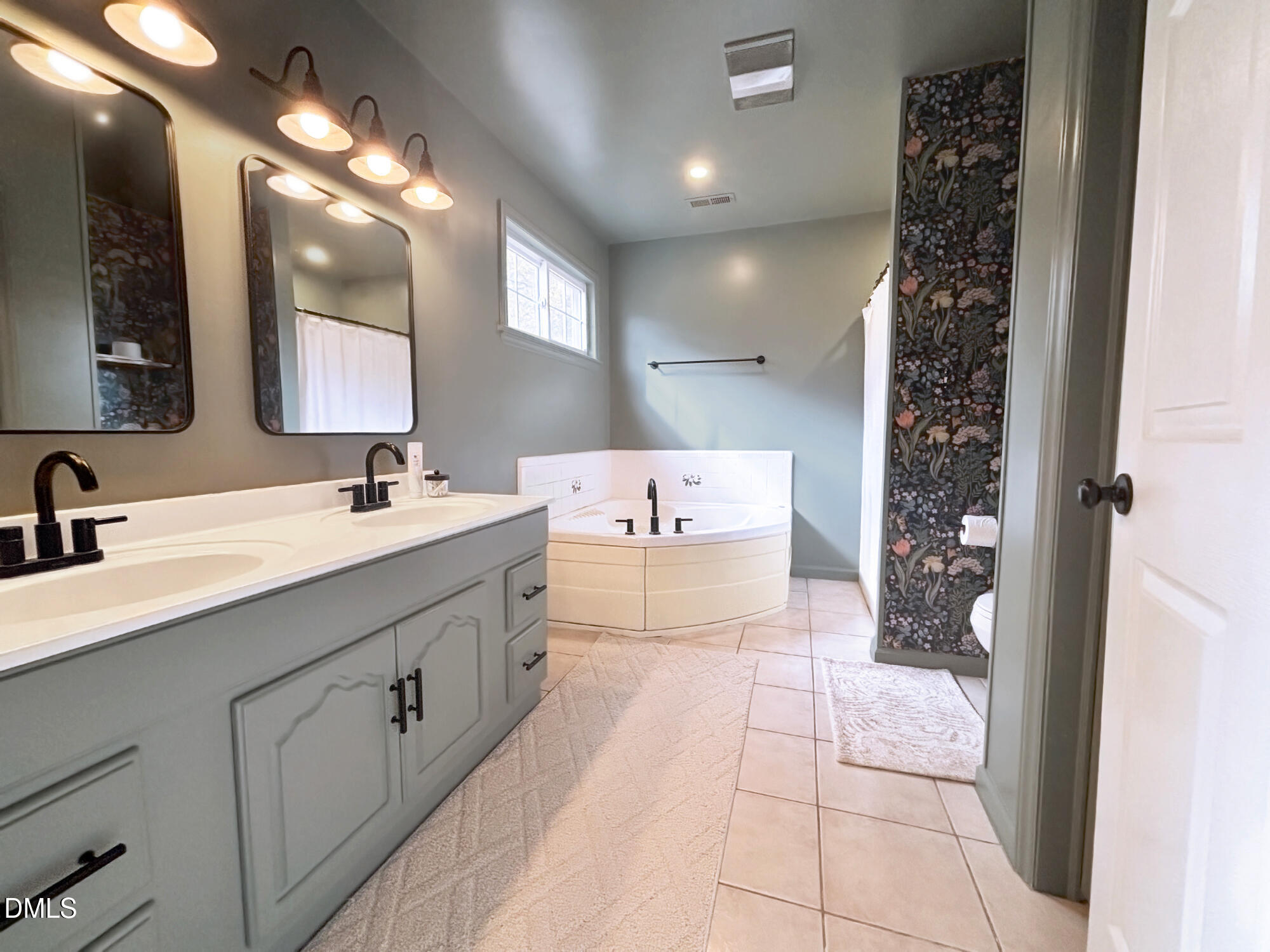 2109 Harris Road Rougemont, NC 27572 - Photo 24 of 35 a spacious bathroom with a double vanity sink mirror and shower