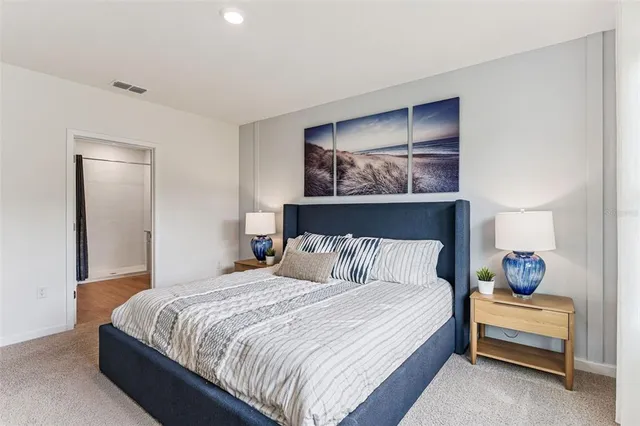 a bedroom with a bed and lamp