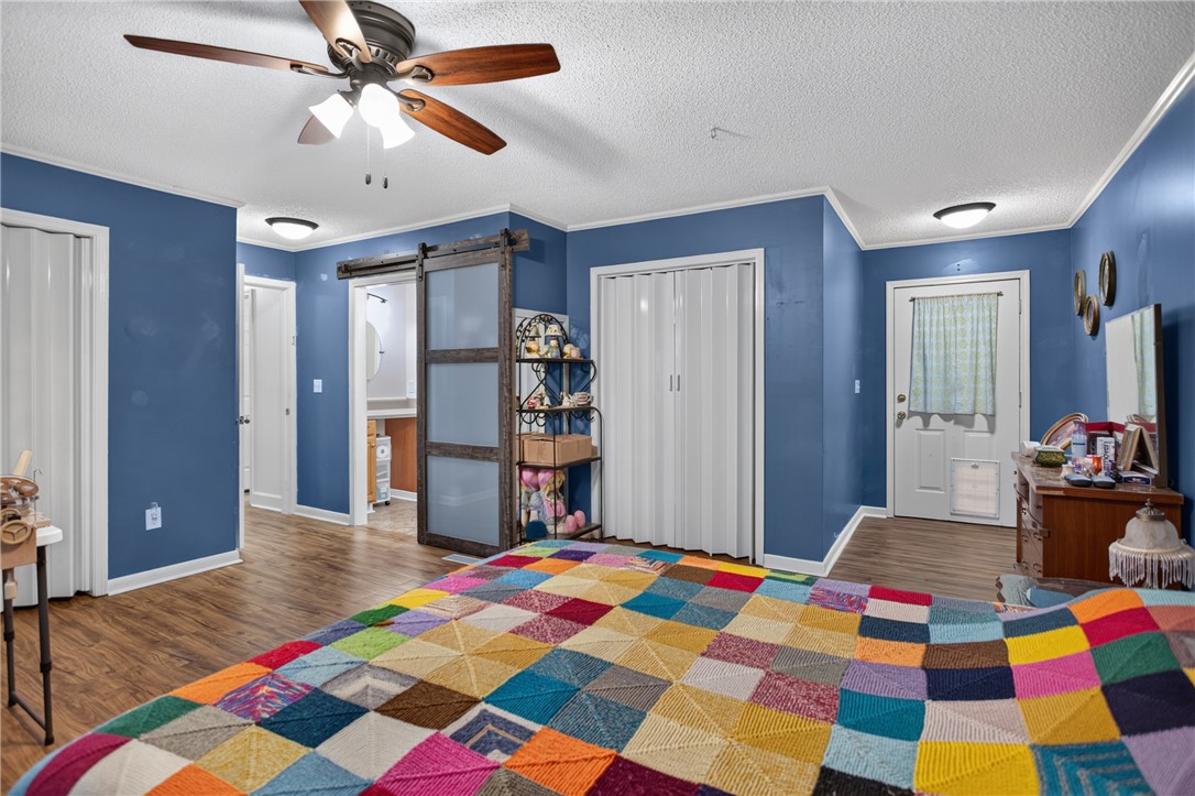 230 Dickard Road Seneca, SC 29672 - Photo 11 of 25 Hardwood floors and a ceiling fan enhance this cozy and practical sleeping area.
