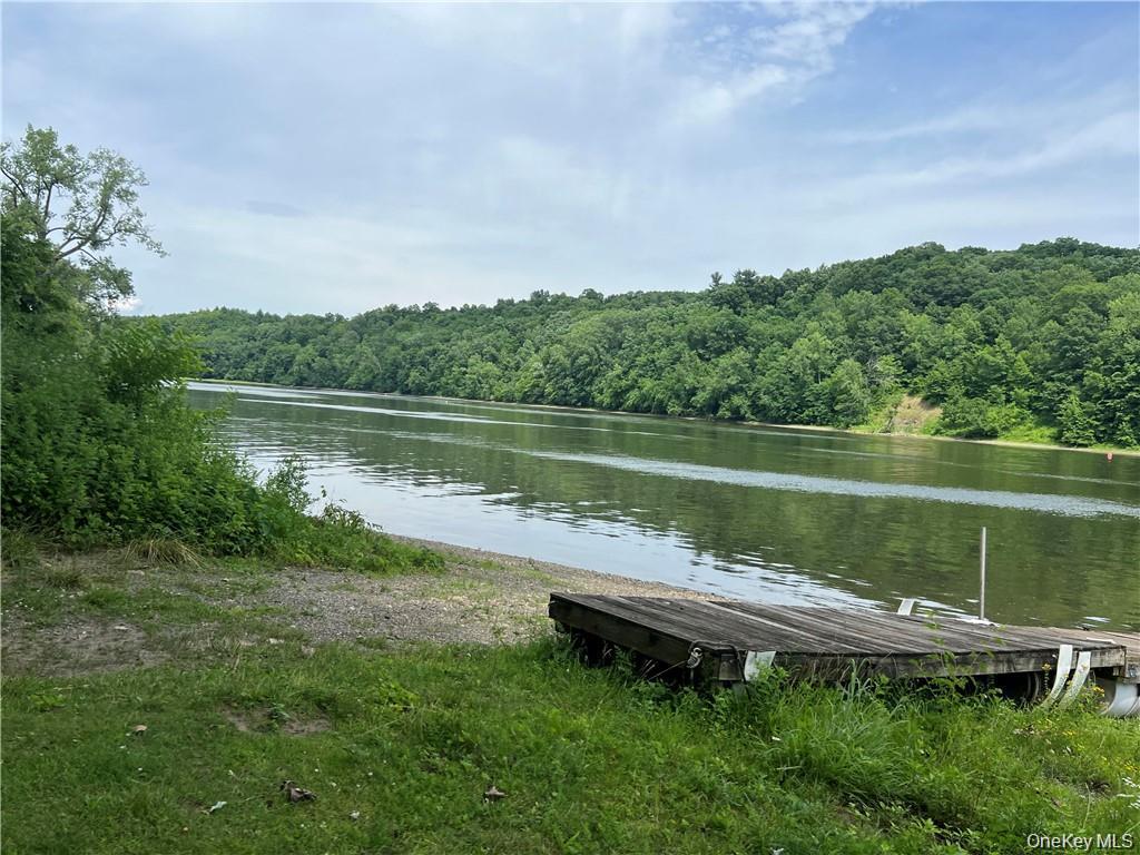 1 Kelts Grove Road Waterford, NY 12188 - Photo 8 of 27 a wooden bench sitting next to a lake