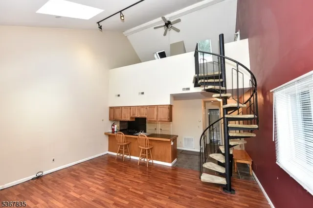 a view of a kitchen with wooden floor and electronic appliances
