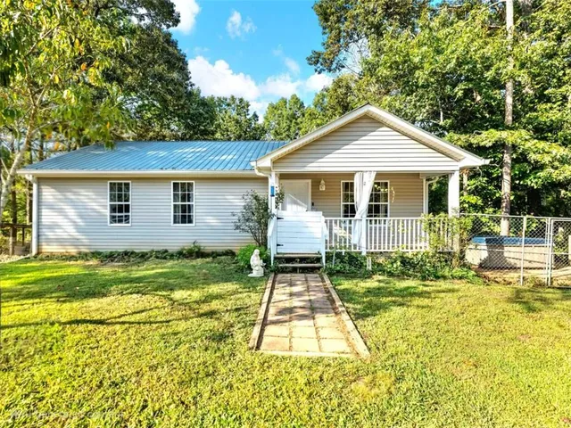 a front view of a house with a yard table and chairs
