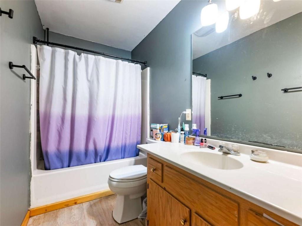 310 Georgian Terrace Alto, GA 30510 - Photo 11 of 39 a bathroom with a sink a toilet and shower curtain