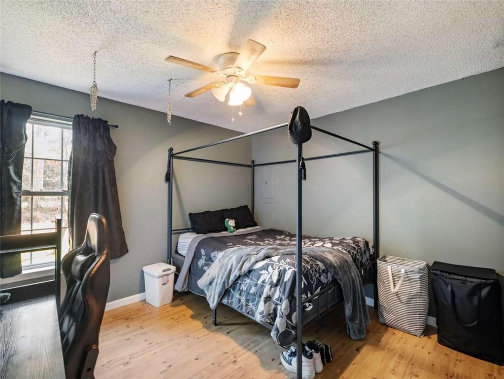 310 Georgian Terrace Alto, GA 30510 - Photo 15 of 39 a bedroom with a bed and a chandelier