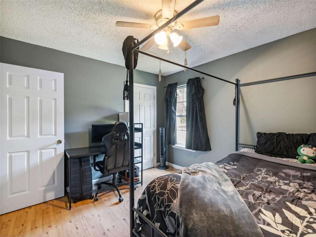 310 Georgian Terrace Alto, GA 30510 - Photo 16 of 39 a bedroom with a bed and a chandelier