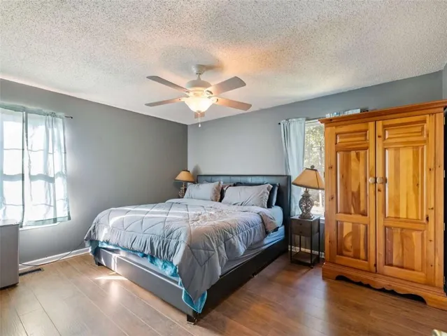 a bedroom with a large bed chandelier and a window