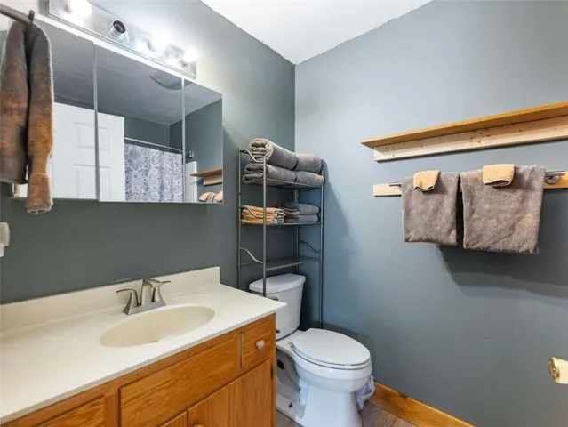 a bathroom with a sink vanity mirror and toilet