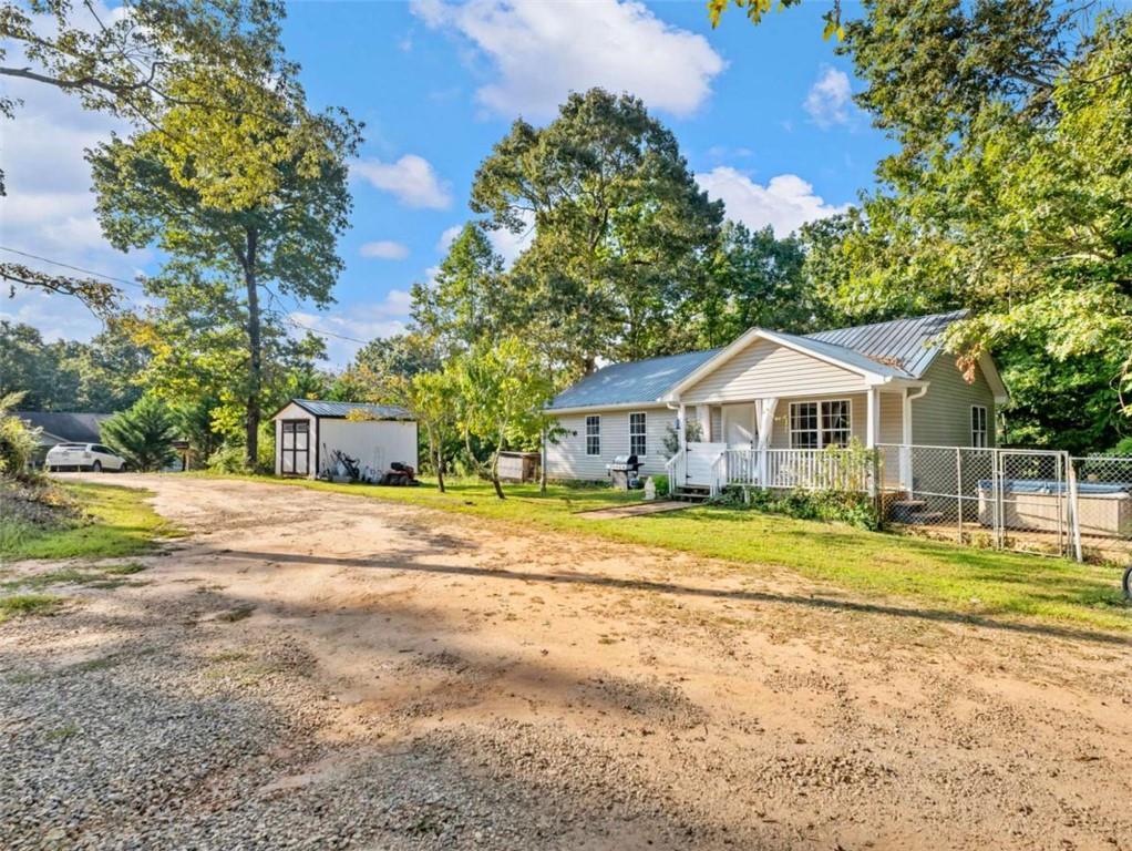 310 Georgian Terrace Alto, GA 30510 - Photo 22 of 39 a front view of a house with a yard and trees