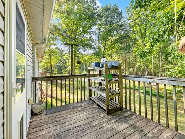 a view of balcony with wooden floor and fence