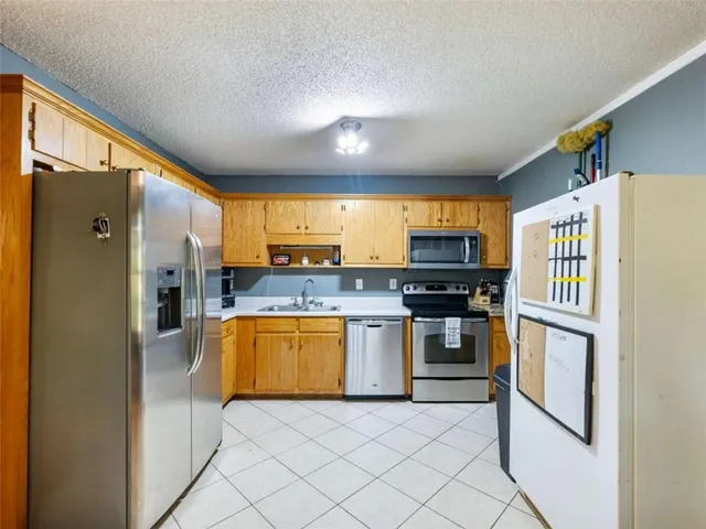 a kitchen with stainless steel appliances granite countertop a refrigerator and a stove