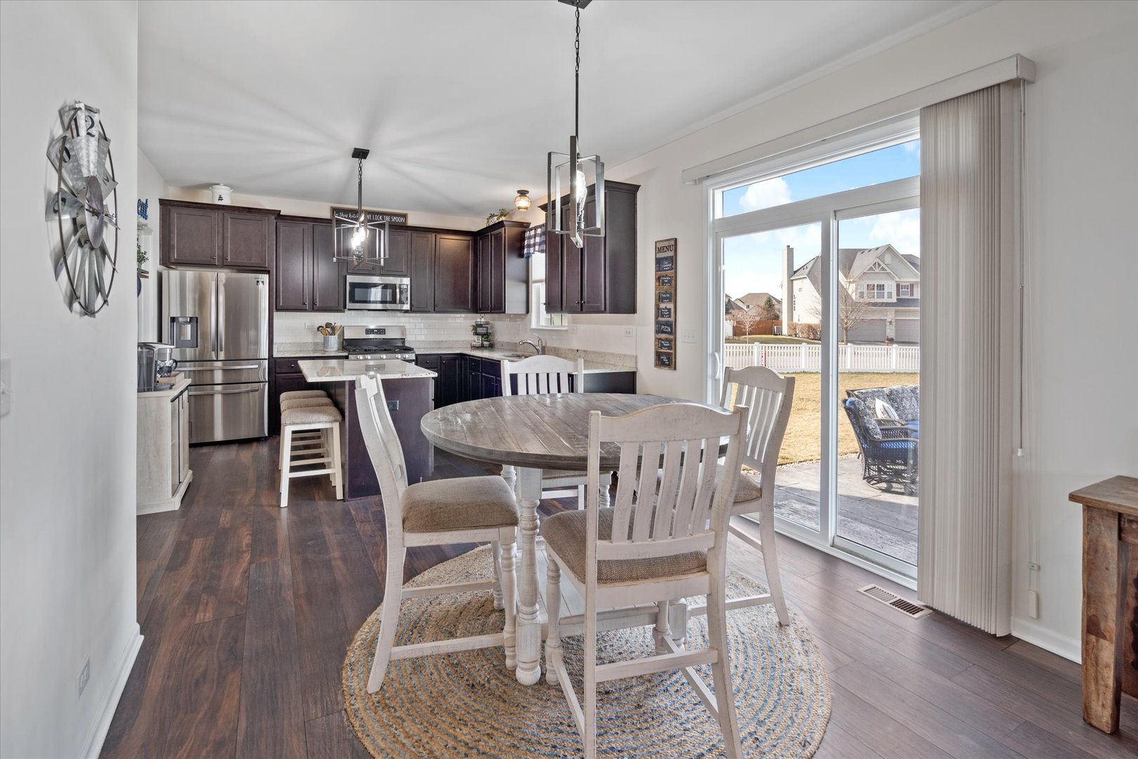 435 Fawn Lane Oswego, IL 60543 - Photo 11 of 26 a view of a dining room with furniture window and wooden floor