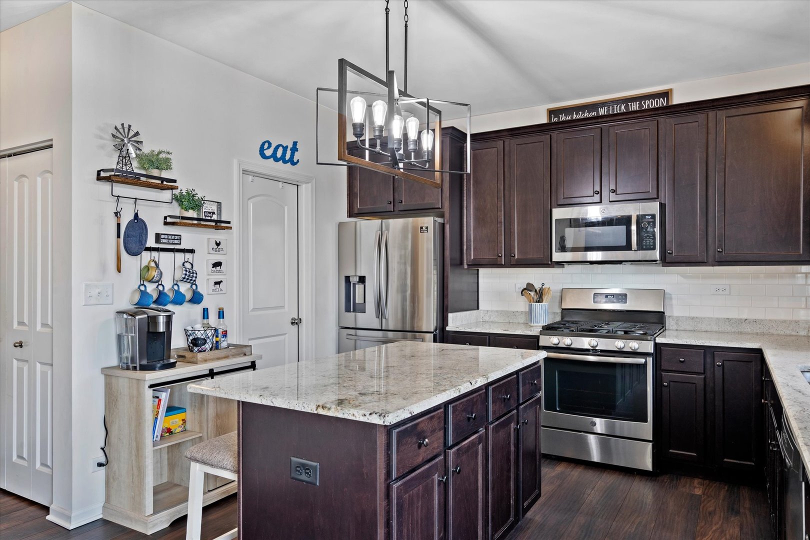435 Fawn Lane Oswego, IL 60543 - Photo 6 of 26 a kitchen with granite countertop a stove cabinets and refrigerator
