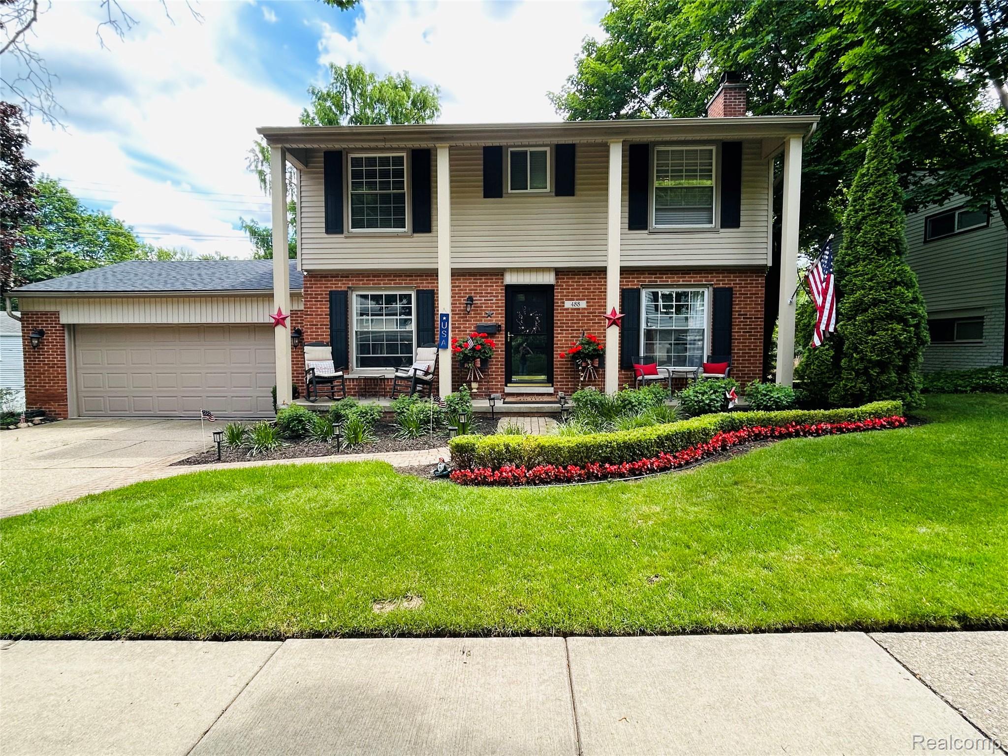 Two-story brick and siding colonial residence with a two-car attached garage