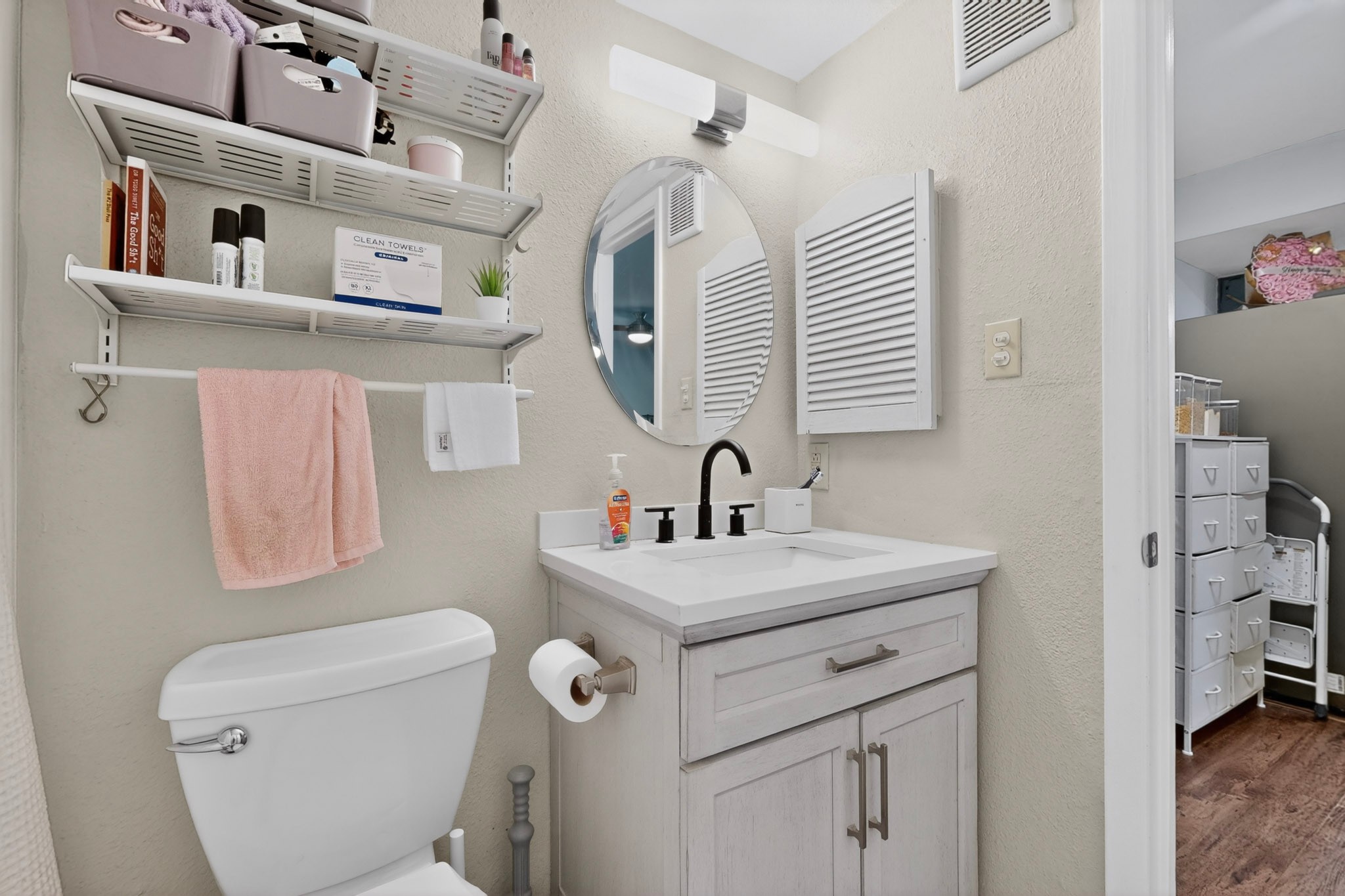 2500 Burleson Road, Unit 506 Austin, TX 78741 - Photo 18 of 23 a bathroom with a sink a toilet and a mirror