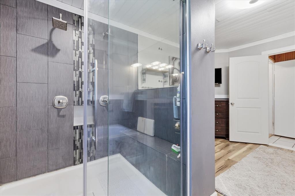 237 Brenda Lane Gainesville, TX 76240 - Photo 22 of 40 Walk-in shower with clear glass enclosure and built-in bench