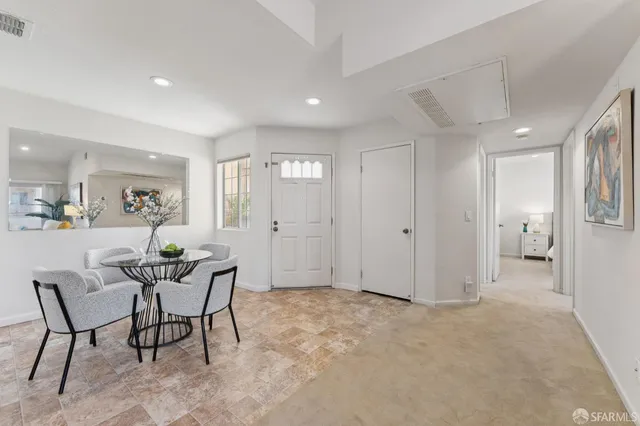 a view of a livingroom with furniture and a dining table chair
