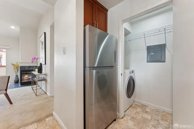 a kitchen with a refrigerator and table