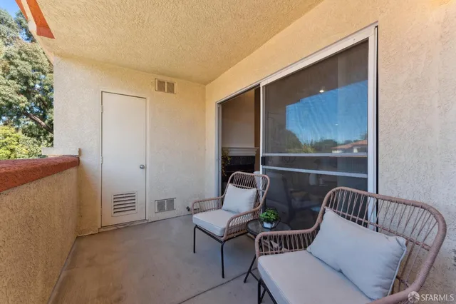 a view of balcony with furniture