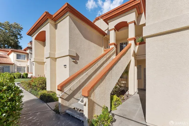 a view of a house with wooden fence