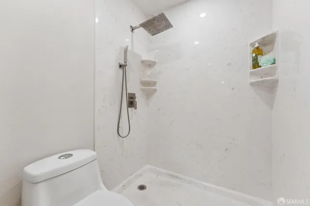a bathroom with a shower and toilet