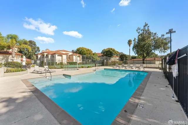 a view of a house with swimming pool and sitting area